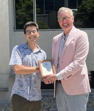 Vedant Chandra receives the 2026 Fireman Fellowship from Dave Carbonneau